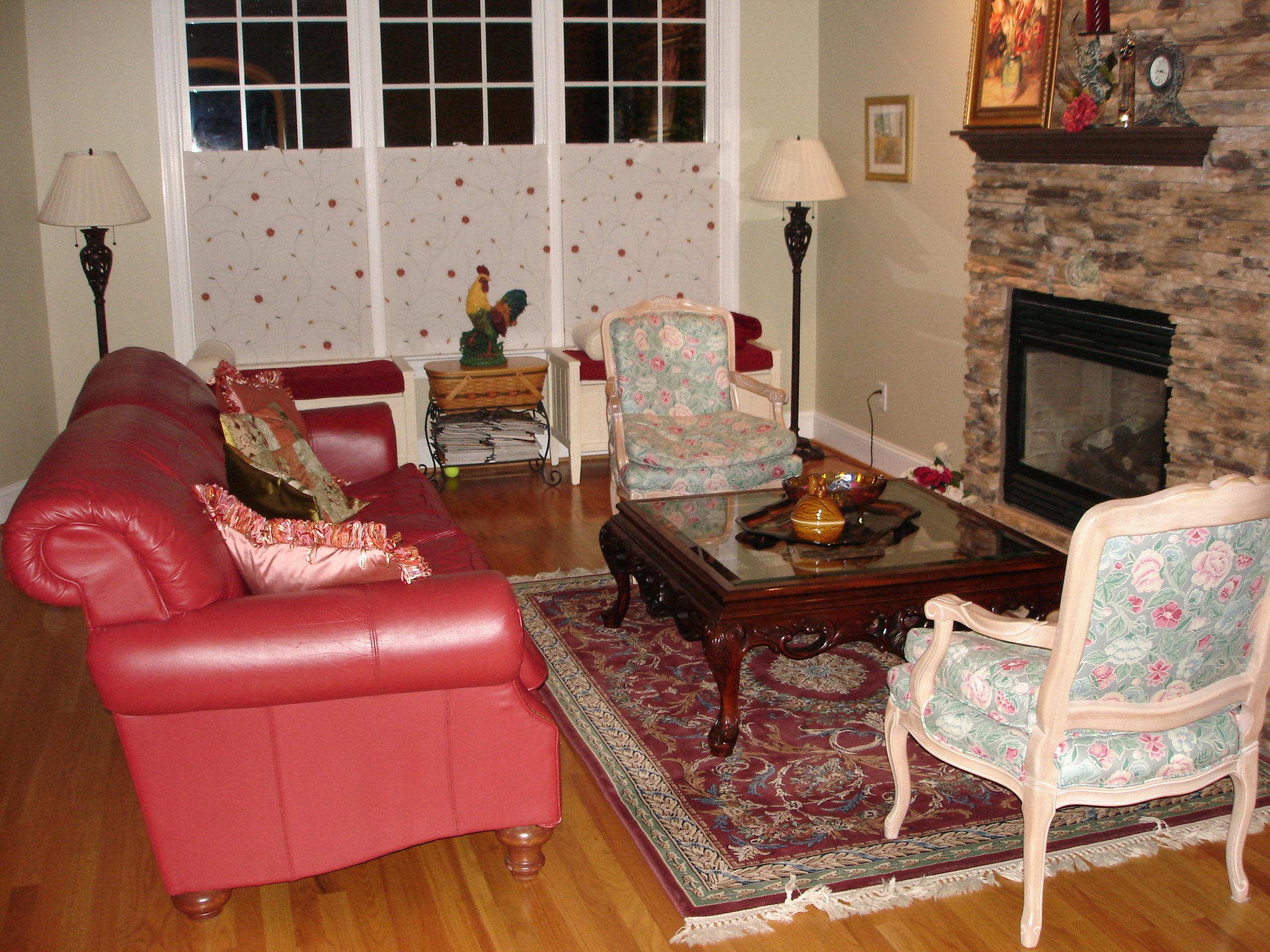 living room with red couch and persian rug